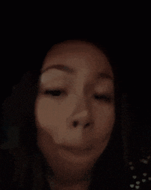 a close up of a woman making a funny face with her mouth open
