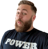 a man with a beard is wearing a black shirt that says power