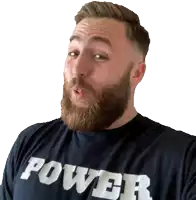 a man with a beard is wearing a black shirt that says power
