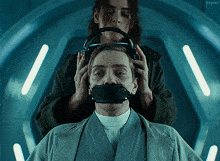 a woman with headphones on a man 's head with the word kepler in the background