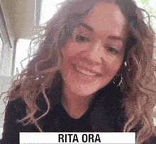a close up of a woman 's face with the name rita ora on it