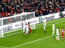 soccer players on a field with a banner that says wasabi