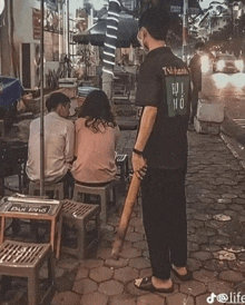 a man wearing a black shirt that says " trihanh "