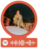 a spotify sticker with a picture of a person kneeling on a ledge