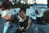 a blurry painting of a man 's face with a blue background