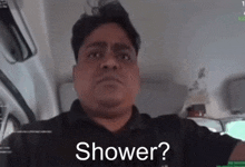 a man in a black shirt with the words shower written on his face