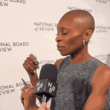a woman is being interviewed with a microphone that says nbr