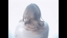 a woman 's back is visible through a white curtain