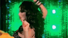 a woman is dancing in front of a green screen