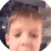 a close up of a child 's face in a circle with the words `` я '' written on the bottom .