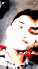 a close up of a man 's face with the name ariyan on the bottom right