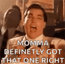 a man in a suit and tie is making a funny face and screaming .