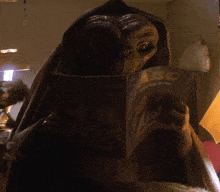 an alien reading a book called abc