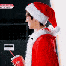 a man in a santa suit is holding a cup that says sweetheart