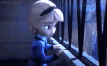 a little girl is looking out of a window with bars .