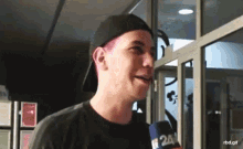 a man with pink hair is talking into a microphone that says 24