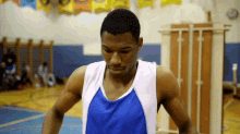 a basketball player in a blue and white tank top