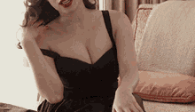 the woman is wearing a black dress and red lipstick