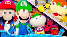a group of stuffed mario , luigi , and bowser are standing next to each other