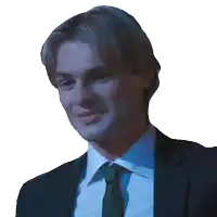 a man in a suit and tie is smiling