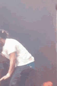 a blurry picture of a man in a white shirt and black shorts