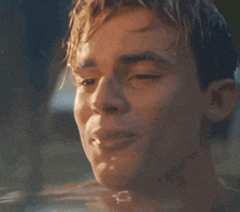 a close up of a man 's face in water