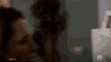 a blurred image of a person with the nbc logo on the bottom