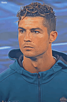 a man with curly hair is wearing a blue jacket with the word reels on the bottom