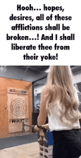 a woman is throwing an axe at a dart board