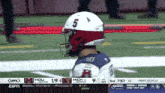 a football player with the number 5 on their helmet