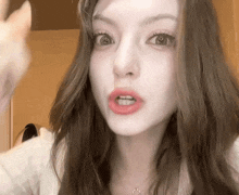 a woman with long hair is making a funny face