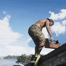 a shirtless man is standing on a rock holding a toolbox and a hammer