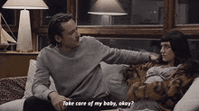 a man and a pregnant woman are sitting on a couch and the man is asking the woman to take care of her baby