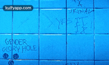 a blue tile wall with the words your ugly written in white
