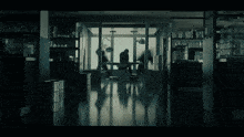 a silhouette of a man standing in a dark room