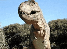 a statue of a t-rex with its mouth open