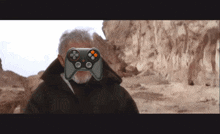 a man with a beard is wearing a video game controller in front of his face