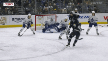 a hockey game is being played in front of a tsn banner