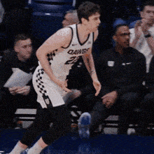 a basketball player wearing a white jersey that says dawgs on it
