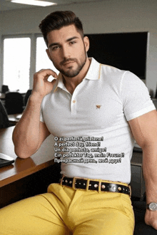 a man in a white shirt and yellow pants is sitting at a table