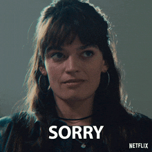 a close up of a woman 's face with the word sorry on it