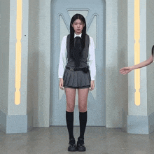a girl in a school uniform with the letter m on her shirt