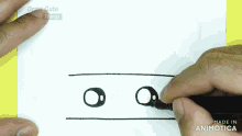 a person is drawing two eyes on a piece of paper with draw cute things written on the bottom