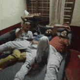 a man wearing a lee cooper shirt laying on a couch