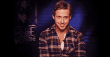 a man is smiling in front of a blue valentine sign