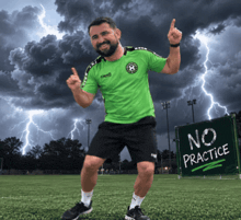 a man in a green shirt is standing in front of a sign that says no practice