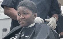 a man is getting his hair cut by a barber