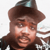 a man wearing a hat and plaid shirt has tiktok written on the bottom of his face