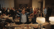 a man with his arms outstretched is surrounded by people