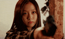 a girl with long hair is holding a gun